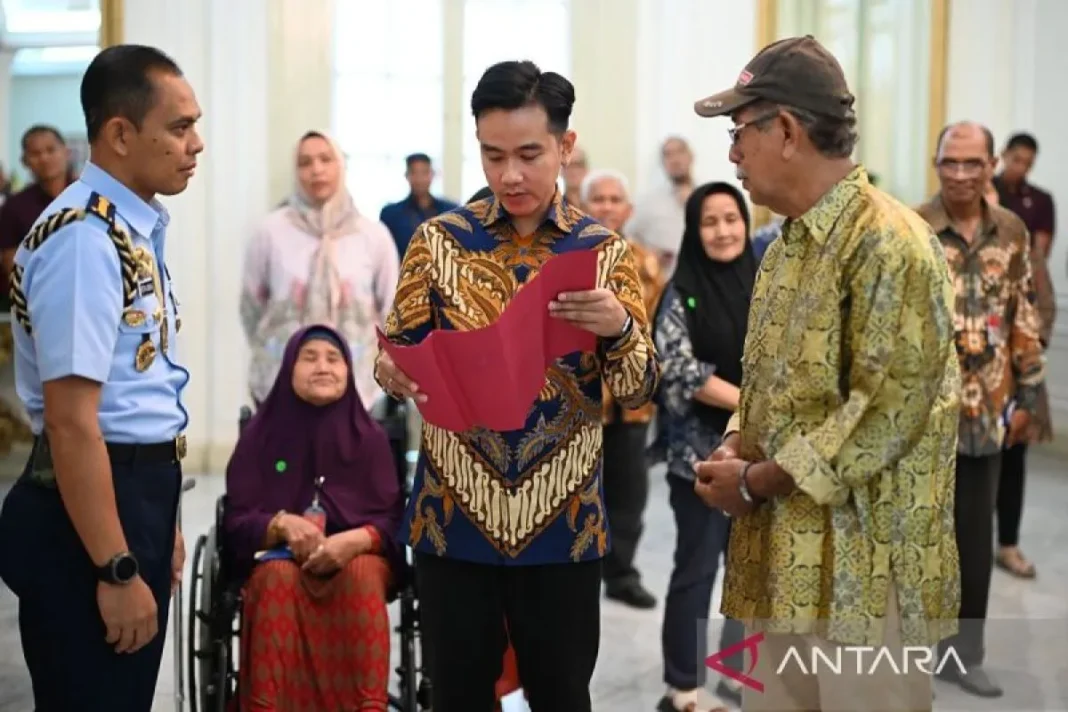 a Wakil Presiden Gibran Rakabuming menyerahkan bantuan kemasyarakatan kepada warga yang sebelumnya mengajukan aduan ke Lapor Mas Wapres di Istana Wakil Presiden Jakarta, Selasa